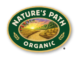 Nature’s Path Organic logo featuring a sunrise over a farm field, fruit on branches, and “Nature’s Path Organic” in white on a green oval—symbolizing their commitment to quality and care, from automated bar line kettles to stretch wrappers.
